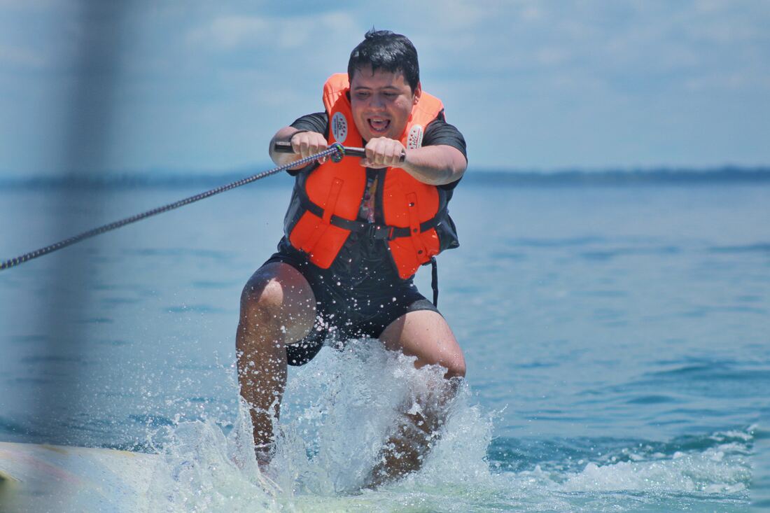 Hombre practicando wakeboard con salpicadura de agua